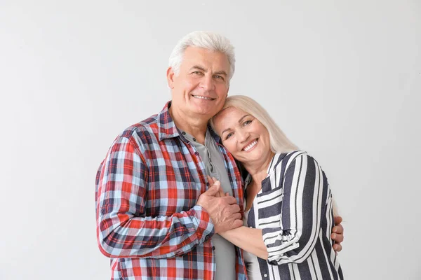 Portrait of happy mature couple on light background — Stock Photo, Image