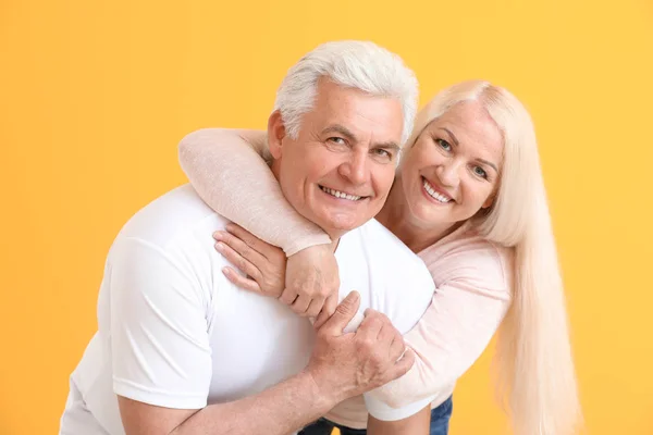 Portrait of happy mature couple on color background — Stock Photo, Image