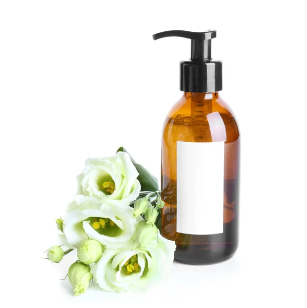 Fles shampoo en bloemen op witte achtergrond — Stockfoto