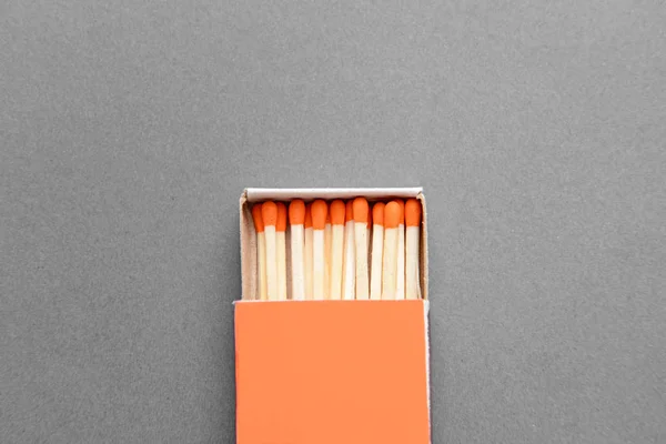 Box with matches on grey background — Stock Photo, Image