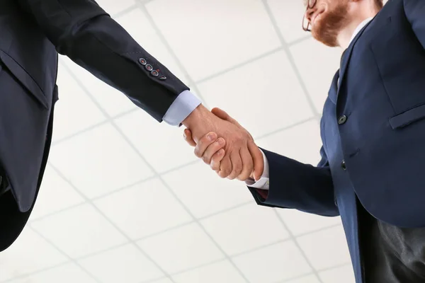 Business partners shaking hands in office — Stock Photo, Image