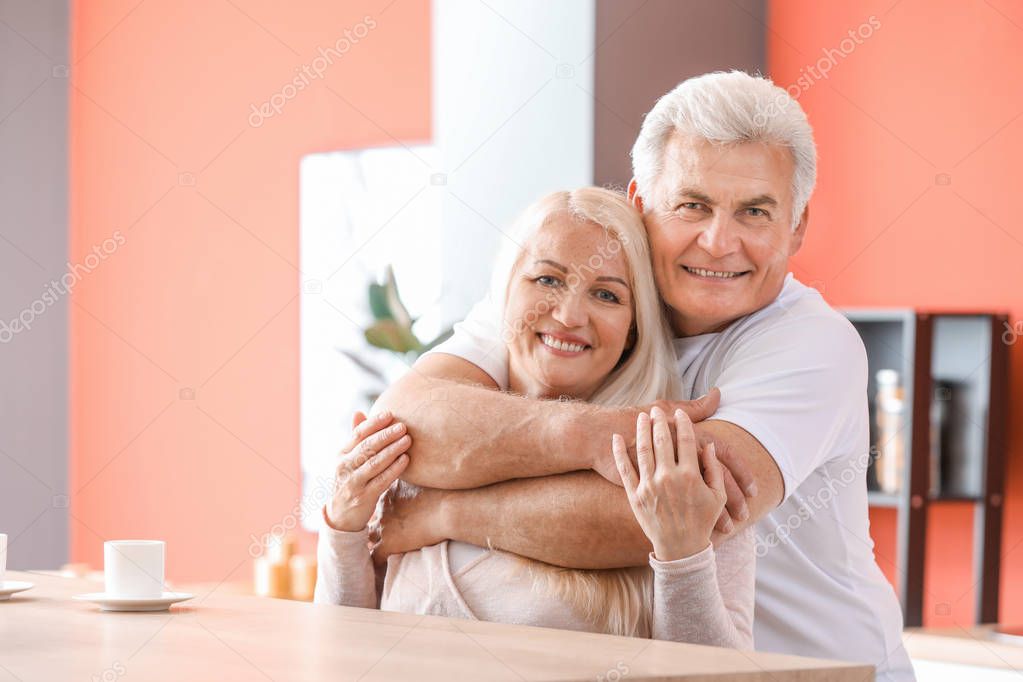 Portrait of happy mature couple at home