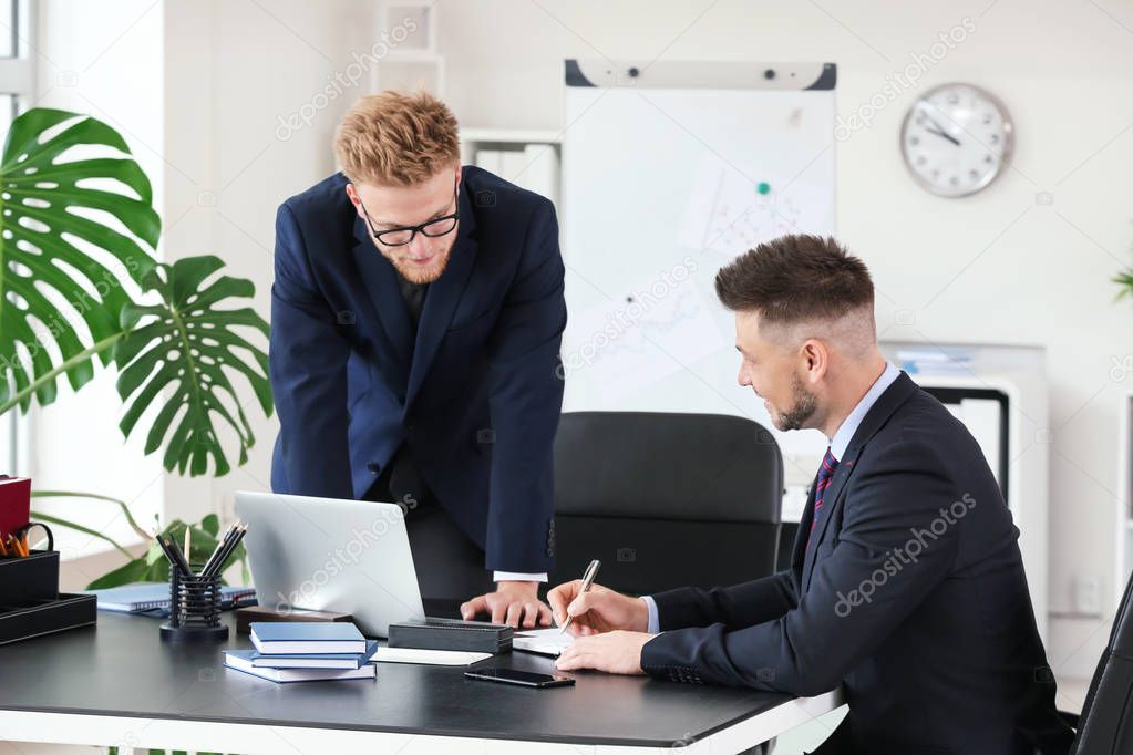 Business partners discussing project in office