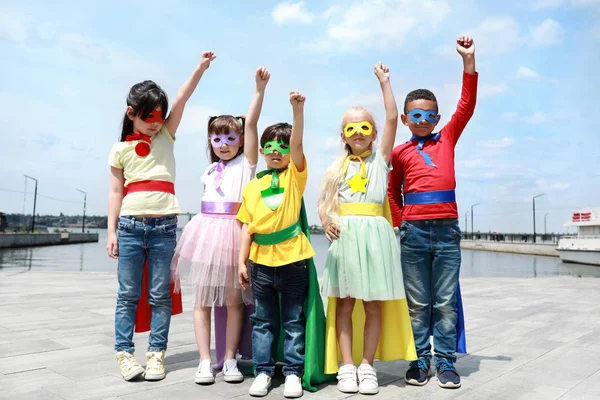 Cute little children dressed as superheroes outdoors — Stock Photo, Image