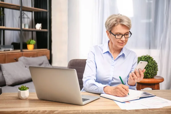 Mature businesswoman working in office — Stock Photo, Image