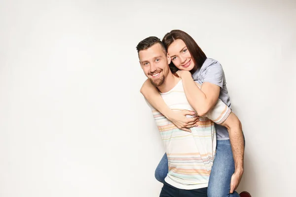 Šťastný mladý pár na světlém pozadí — Stock fotografie
