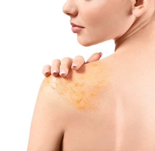 Young woman with orange body scrub on her body against white background, closeup — Stock Photo, Image