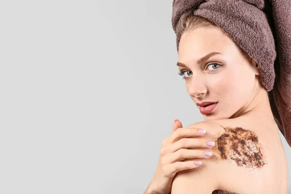 Young woman with body scrub on her body against grey background — Stock Photo, Image