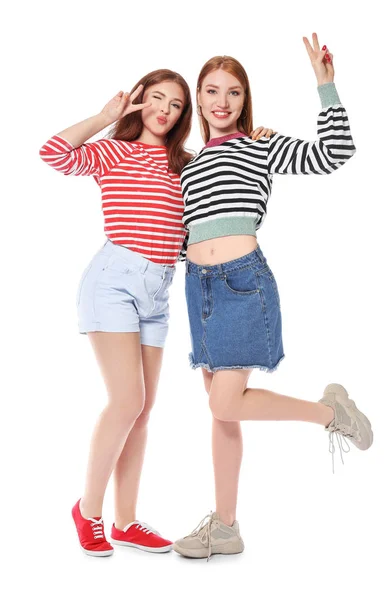 Portrait of happy young women showing victory gesture on white background — Stock Photo, Image