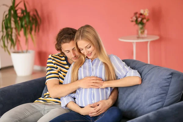 Happy young pregnant couple at home — Stock Photo, Image