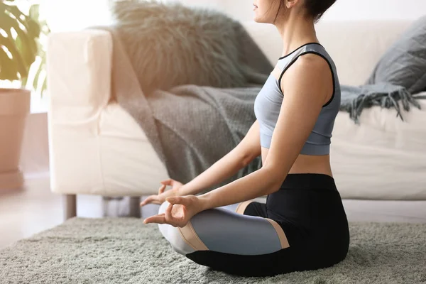 Young woman practicing yoga at home — Stock Photo, Image