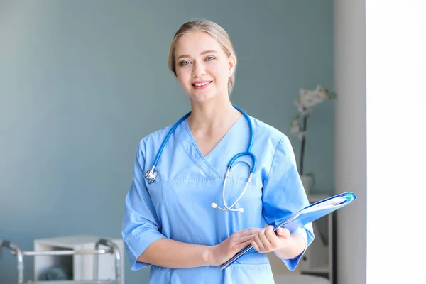 Medical assistant with documents in clinic