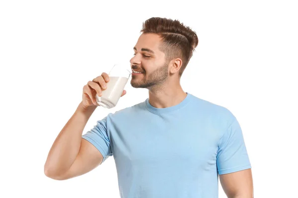 Schöner Mann trinkt leckere Milch auf weißem Hintergrund — Stockfoto