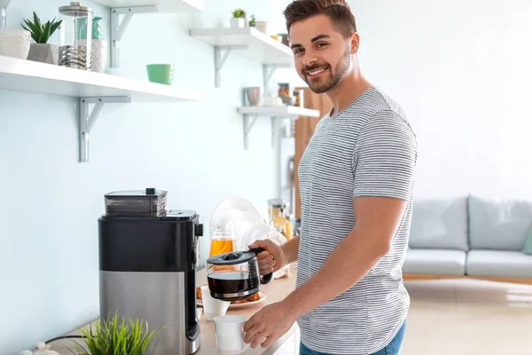 Красивий чоловік використовує кавоварку на кухні — стокове фото