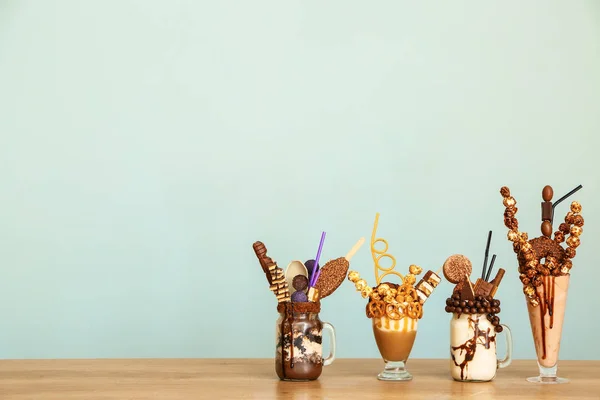 Delicious freak shakes on table against grey background — Stock Photo, Image