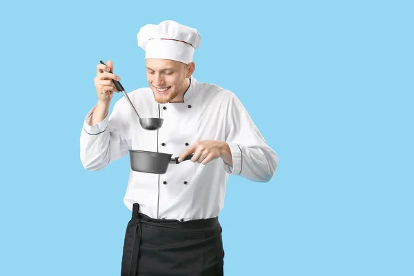 Knappe mannelijke chef-kok met saus op kleur achtergrond — Stockfoto