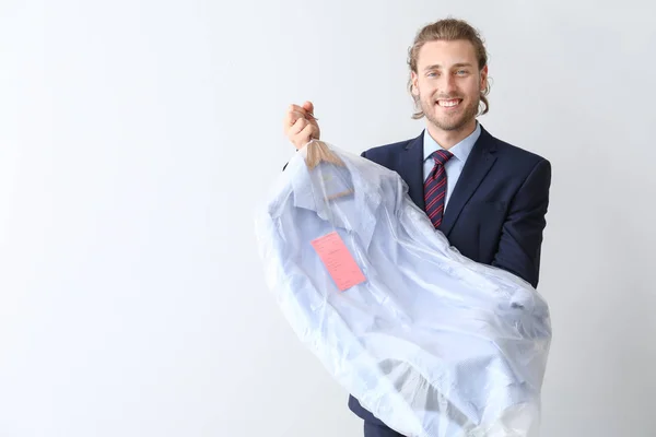 Businessman with clothes after dry-cleaning on white background — Stock Photo, Image