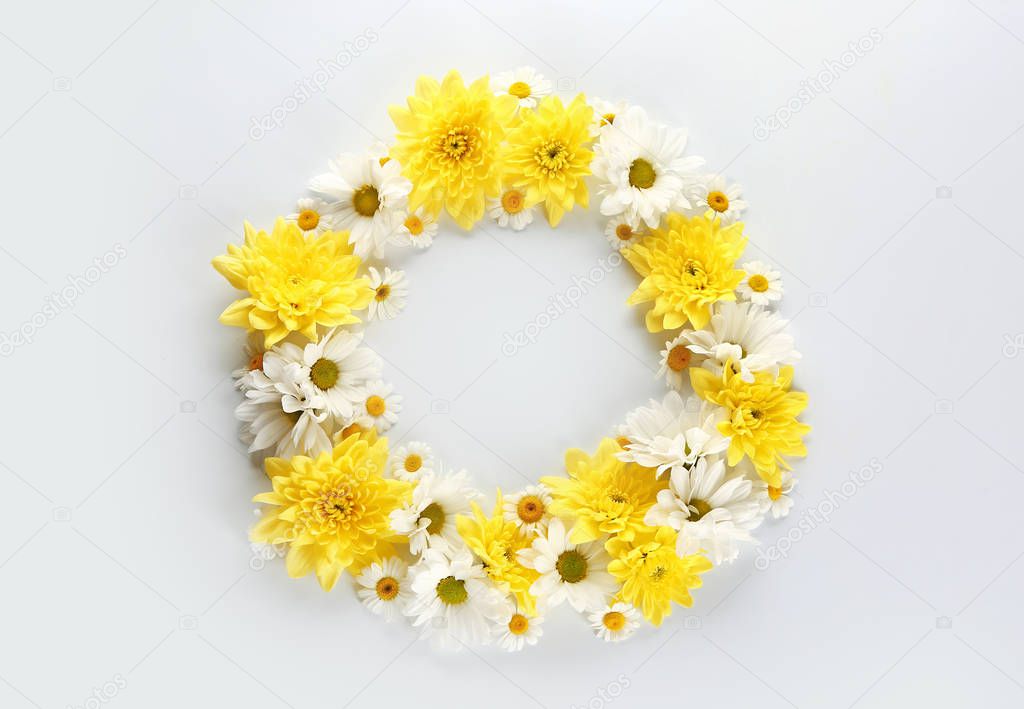 Frame made of beautiful flowers on white background