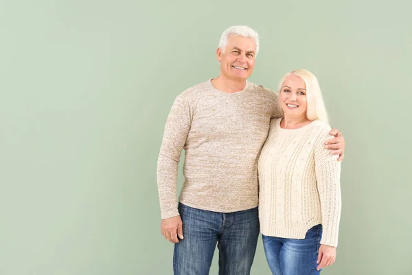 Portrait of happy mature couple on color background — Stock Photo, Image