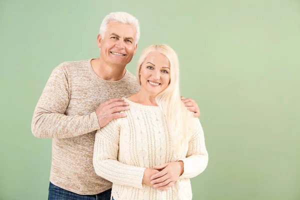 Portrait of happy mature couple on color background — Stock Photo, Image