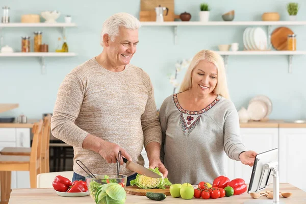 Retrato de pareja madura feliz cocinando en la cocina —  Fotos de Stock