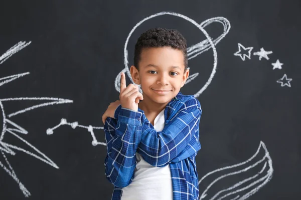 Cute African-American boy near dark wall with drawn space — Stock Photo, Image