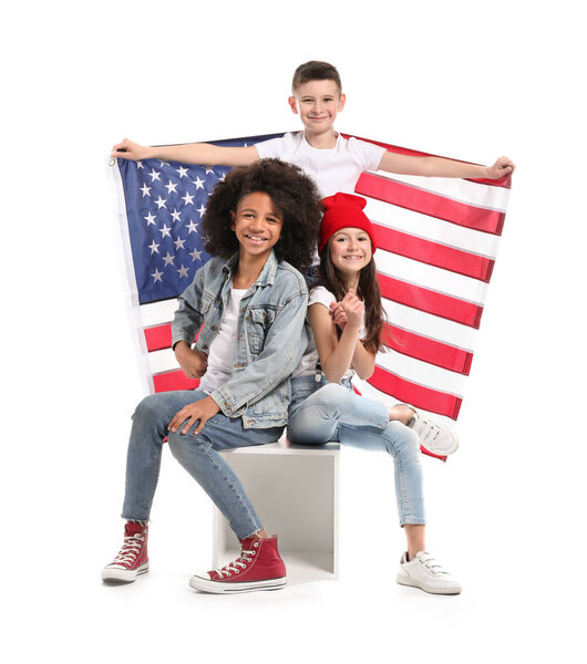 Cute children with national flag of USA on white background