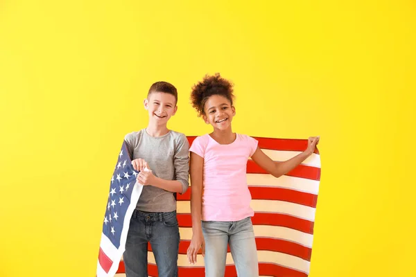 Cute children with national flag of USA on color background Stock Image