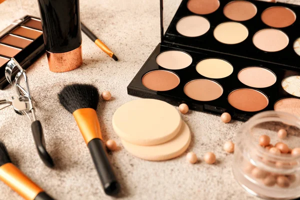 Set of cosmetics for contouring makeup on grey background — Stock Photo, Image