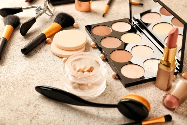 Set of cosmetics for contouring makeup on grey background — Stock Photo, Image