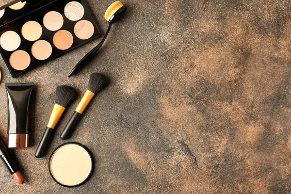 Set of cosmetics for contouring makeup on grey background — Stock Photo, Image