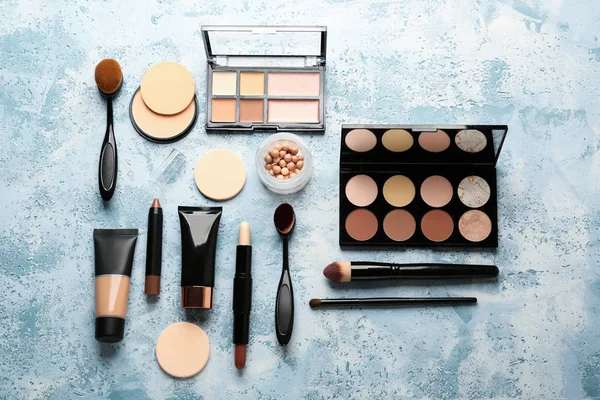 Set of cosmetics for contouring makeup on color background