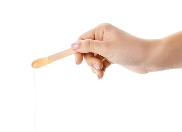 Mână de sex feminin cu pastă de zahăr pe stick pe fundal alb — Fotografie, imagine de stoc