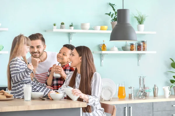 Fiatal család iszik ízletes tej a konyhában otthon — Stock Fotó