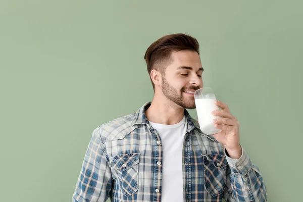 Yakışıklı adam renkli arka planda lezzetli süt içme — Stok fotoğraf