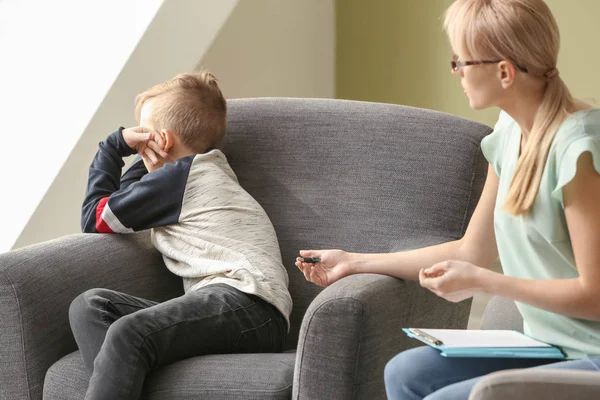 Female psychologist working with naughty little boy in office — Stock Photo, Image