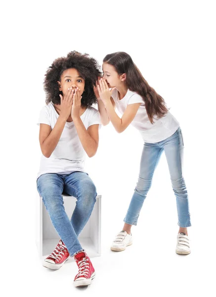 Gossiping girls in jeans on white background — Stock Photo, Image