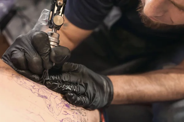 Szakmai artist making tattoo in salon, closeup — Stock Fotó