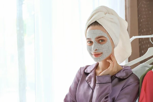 Young woman with facial mask at home — Stock Photo, Image