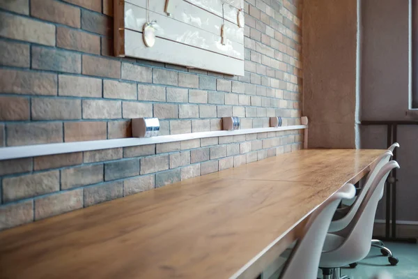 Big wooden table in interior of modern office — Stock Photo, Image