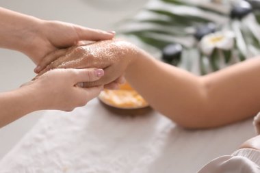 Spa salonunda vücut fırçası ile tedavi gören genç kadın, yakın çekim