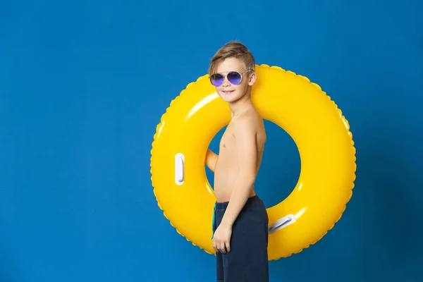 Cute little boy with inflatable ring on color background — Stock Photo, Image