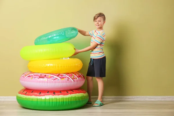 Cute little boy with inflatable rings near color wall — Stock Photo, Image