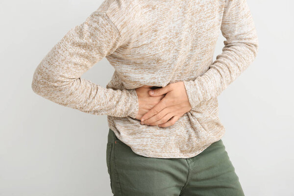 Man suffering from pain in side on white background