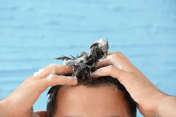 Knappe man haar op kleur achtergrond wassen — Stockfoto