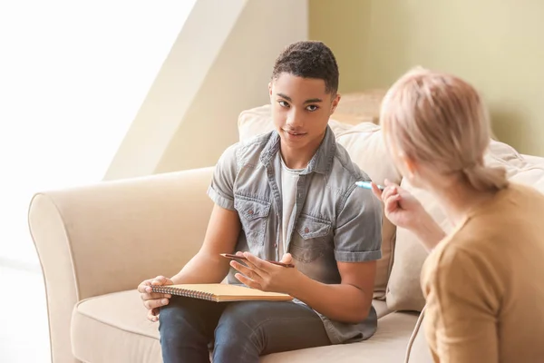 Female psychologist working with teenage boy in office — Stock Photo, Image