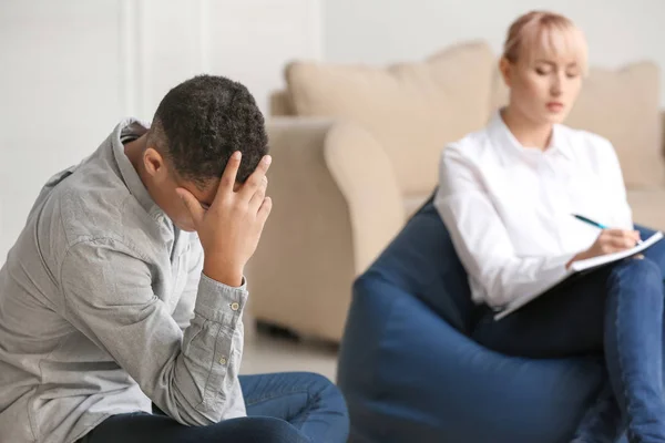 Female psychologist working with teenage boy in office — Stock Photo, Image