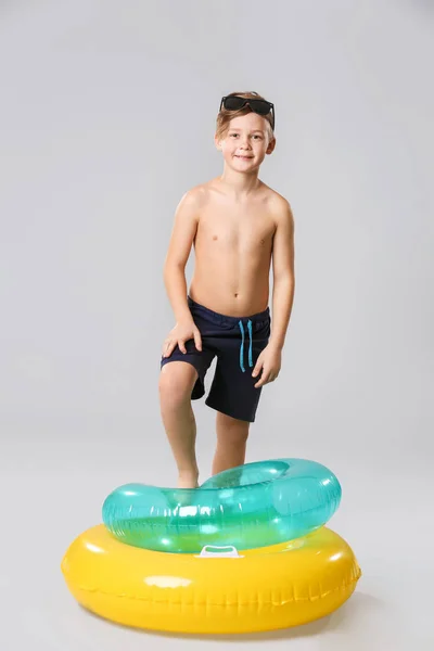 Cute little boy with inflatable rings on grey background — Stock Photo, Image