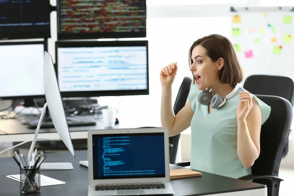 Happy female programmer working in office — Stock Photo, Image