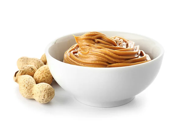 Bowl with tasty peanut butter on white background — Stock Photo, Image